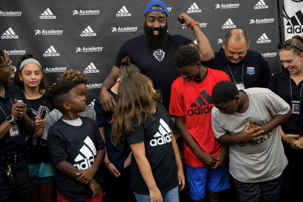 Rockets player James Harden poses with children from the Greater Houston Police Activities League in Houston, Friday, July 19, 2019. Ten children from the GHPAL received a $200 Academy gift card, Adidas Harden basketball shoes and a complimentary entry to James’ ProCamp.