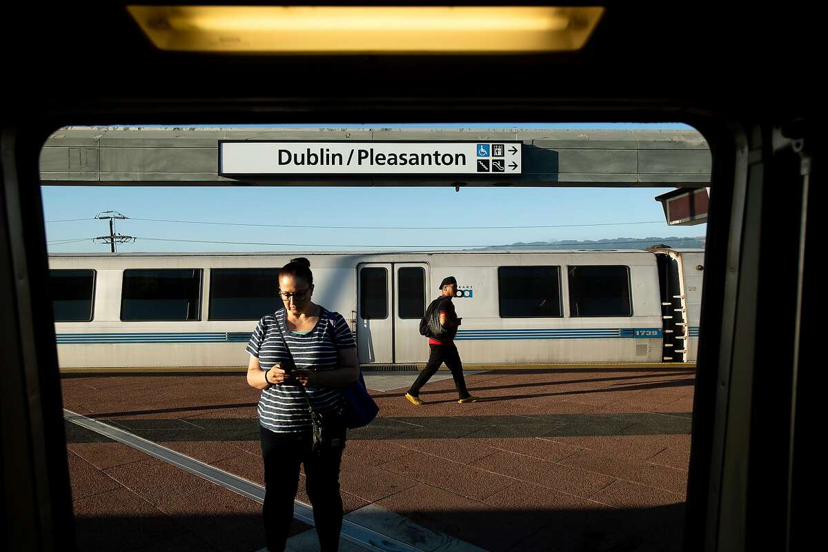 Commuters cross the platform at BART's Dublin/Pleasanton station on Friday, July, 19, 2019, in Pleasanton, Calif.