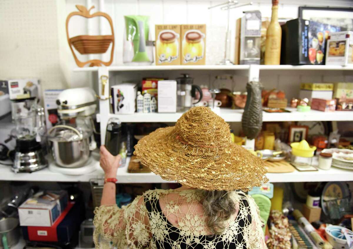 Myrna Hollinger, of Stamford, browses knick knacks for sale during the 54th grand re-opening at the Rummage Room in Old Greenwich last September. The Rummage Room will be closed for most of August for restocking before the grand opening in September and several days of sales will be held first.