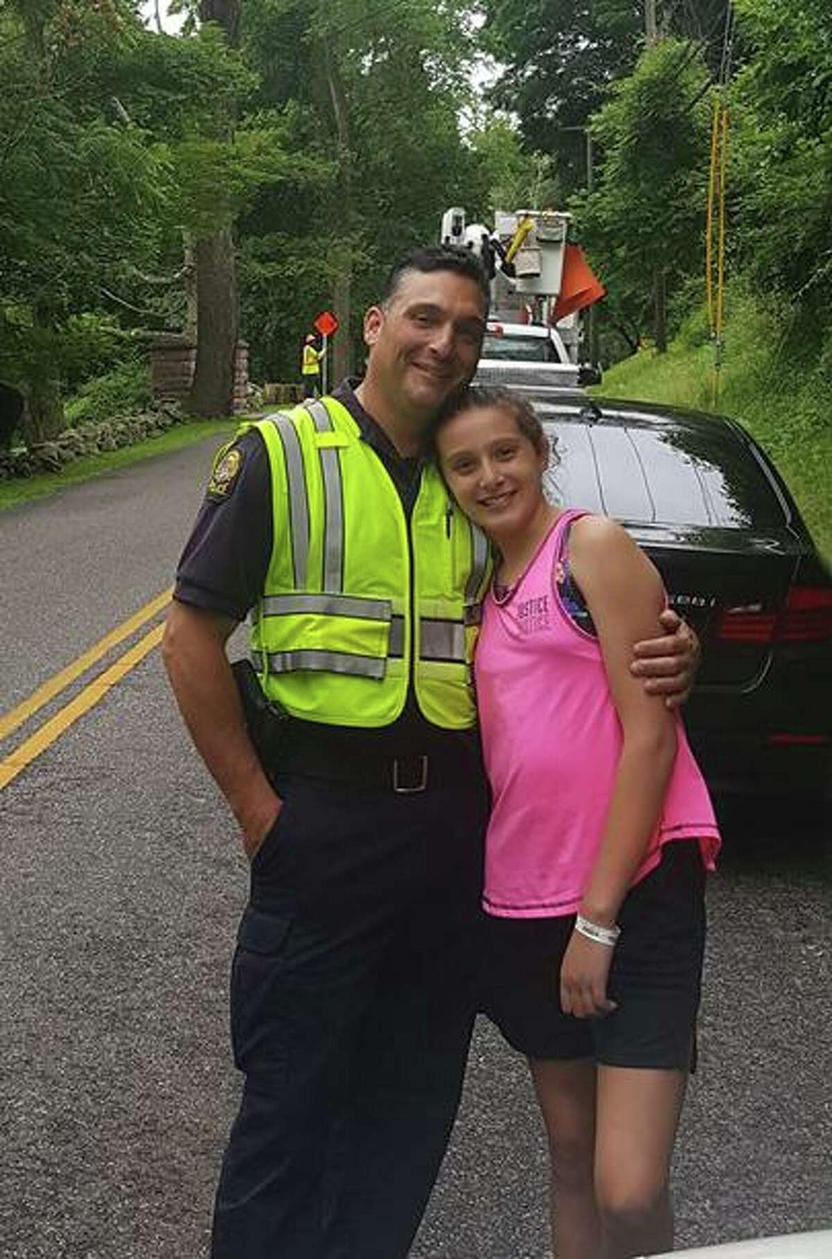 Ava Lombardo, of Newtown, with her dad, Lt. Robert Lombardo of the Greenwich Police Department. Ava will host a lemonade stand in Greenwich on Saturday to benefit the Catherine Violet Hubbard Animal Sanctuary in Newtown.