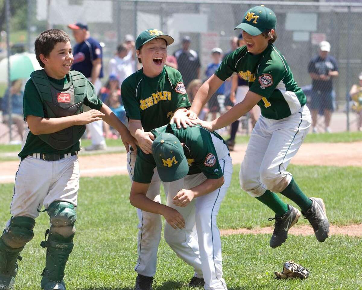 New Milford players, back row left to right, Robert Mosso, Brendan Profita and Tim Gesualdi celebrate with Tyler Hansen, who pitched the last three innings. New Milford defeated Danbury, 10-6, to win the Cal Ripken 11-year-old state tournament championship Saturday at Rogers Park.