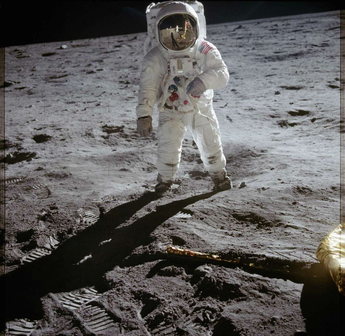 (1969-07-20) This photo is of Edwin Aldrin walking on the lunar surface. Neil Armstrong, who took the photograph, can be seen reflected in Aldrin?•s helmet visor. Armstrong was the first human to ever stand on the lunar surface.
