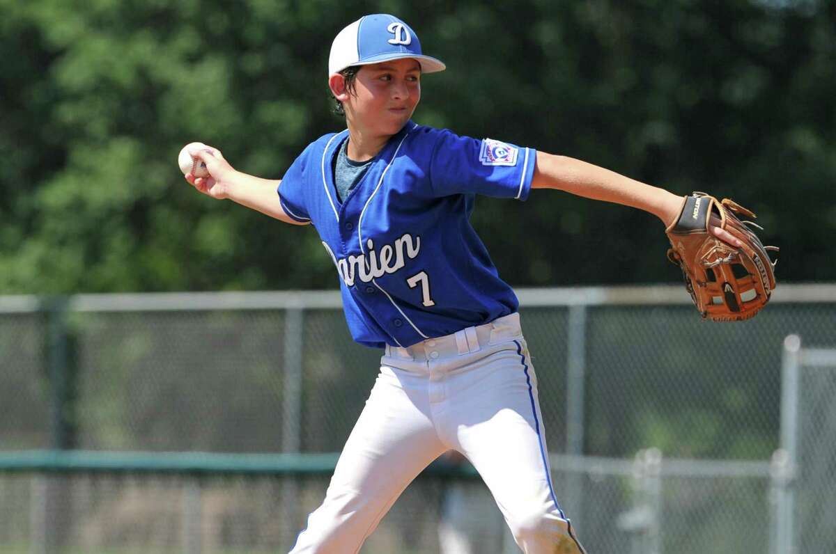 Aiden Elders (7) of Darien delivers a pitch during a Section 1 game against Fairfield American on Sunday at Unity Park in Trumbull.