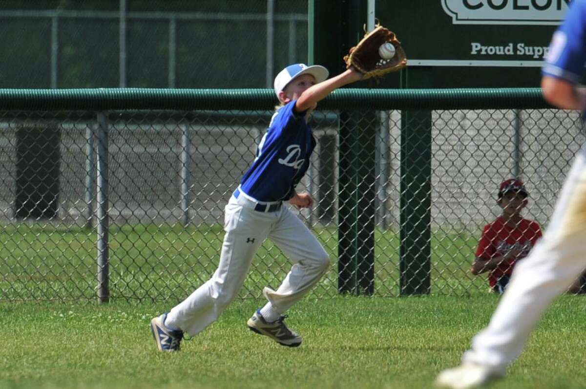 Tommy Karczawski (9) of Darien makes a running catch during a Section 1 game against Fairfield American on Sunday July 21, 2019 at Unity Park in Trumbull, Connecticut.