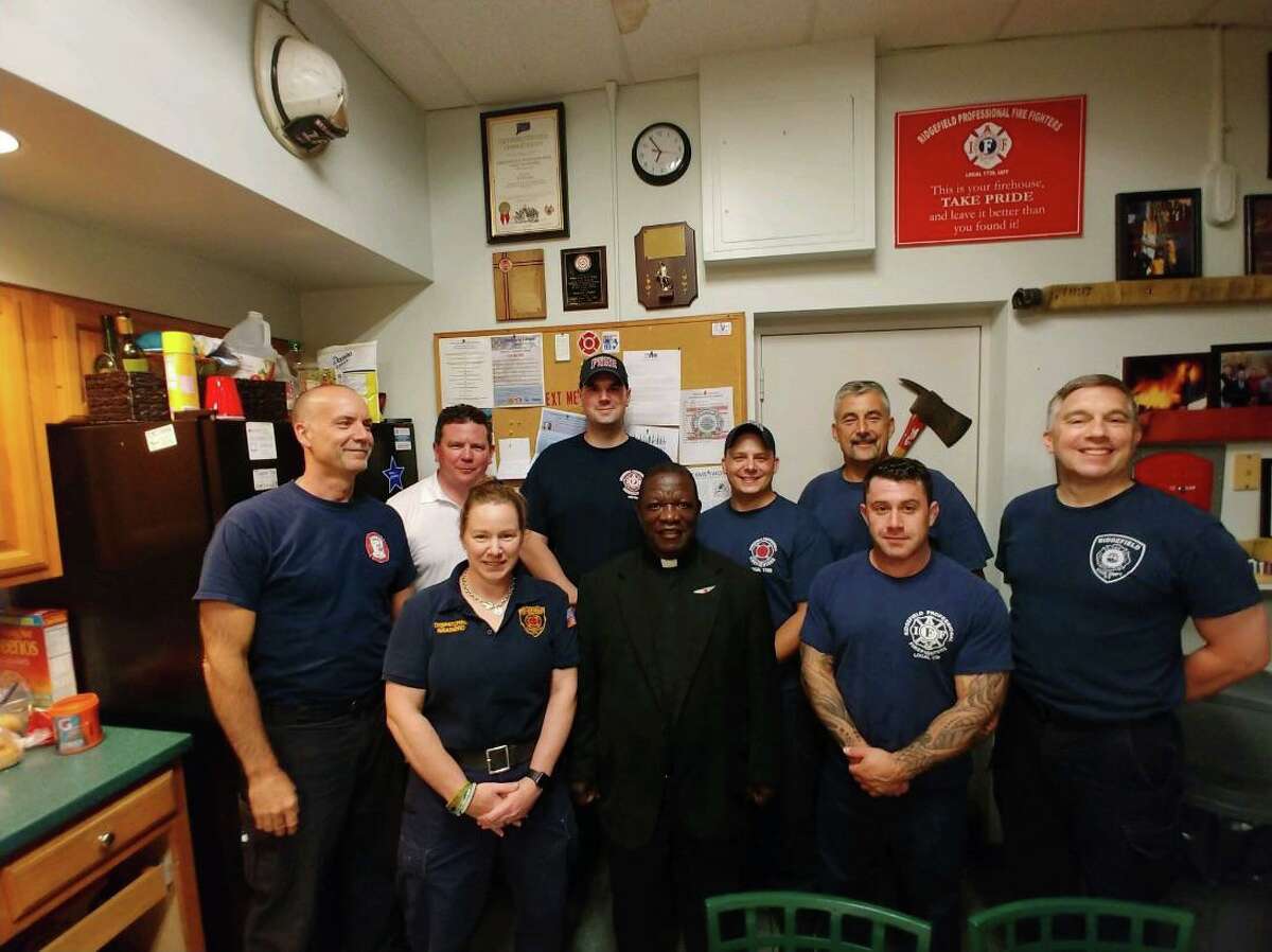 Father Joseph Dube, who was visiting St. Mary’s Parish all the way from the Diocese of Sokoto in northern Nigeria, dropped by the Ridgefield Fire Department headquarters on Catoonah Street earlier this week. Ridgefield Capt. Richard Lawlor, an ordained Deacon, brought Father Dube for a tour of headquarters.