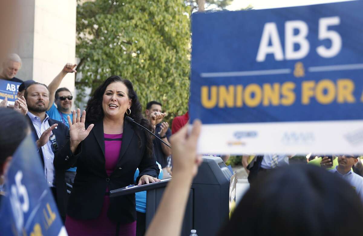 Assemblywoman Lorena Gonzalez, D-San Diego, speaks at a rally after her measure to limit when companies can label workers as independent contractors was approved by a Senate committee, in Sacramento, Calif., Wednesday, July 10, 2019. The measure, AB5, is aimed at major employers like Uber and Lyft. The bill still needs approval by the full Senate. (AP Photo/Rich Pedroncelli)