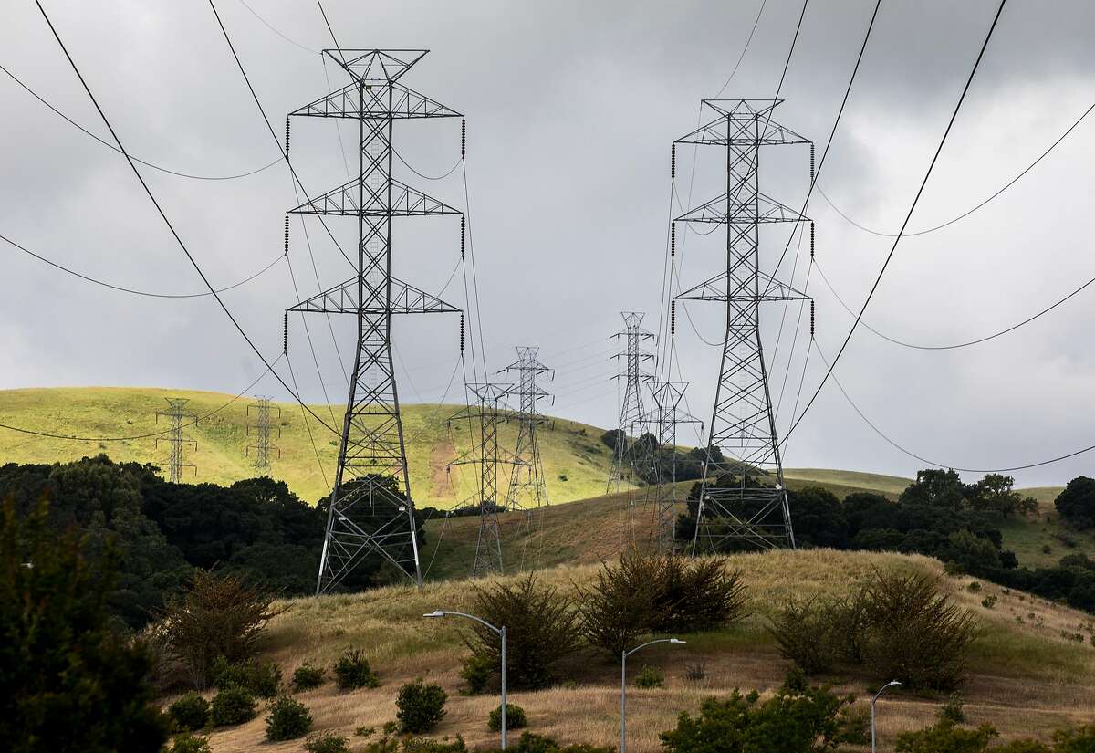 High-voltage power transmission lines owned by PG&E are seen stretched across a neighborhood in western San Ramon, Calif. Friday, May 17, 2019.