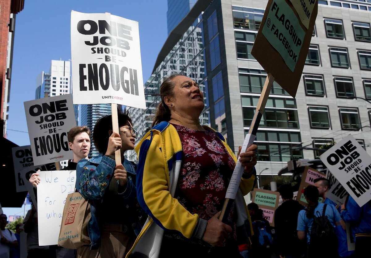 Unite Here Local 2 members, Flagship cafeteria contract workers and supporters march with signs during a protest held outside of the Facebook offices in San Francisco, Calif. Tuesday, July 16, 2019.