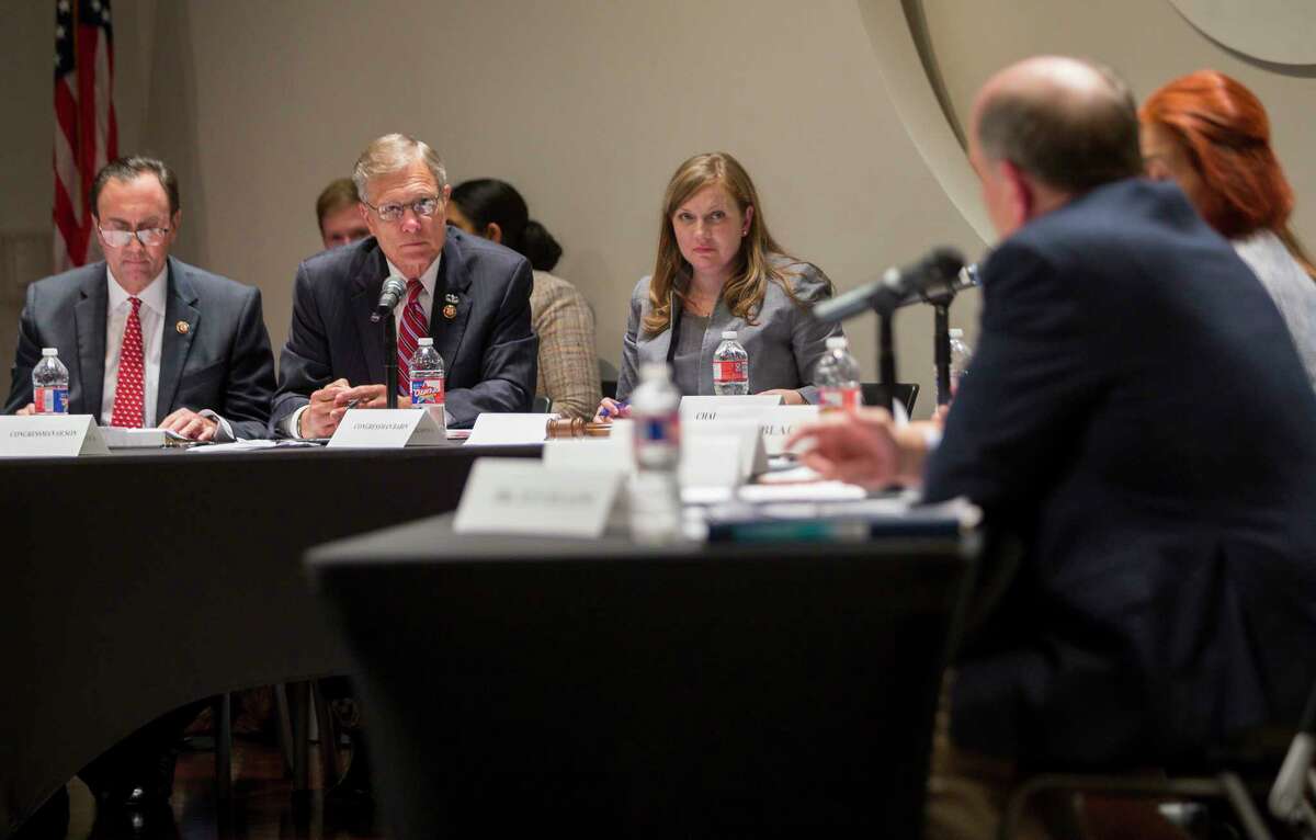 Left to right, U.S. Reps. Pete Olson, R-Sugar Land, Brian Babin, R-Woodville, and Lizzie Fletcher, D-Houston, listen to Louis W. Uccellini, director of the National Weather Service, provide testimony at a House environment subcommittee field hearing at Houston Community College in Houston, Monday, July 22, 2019.