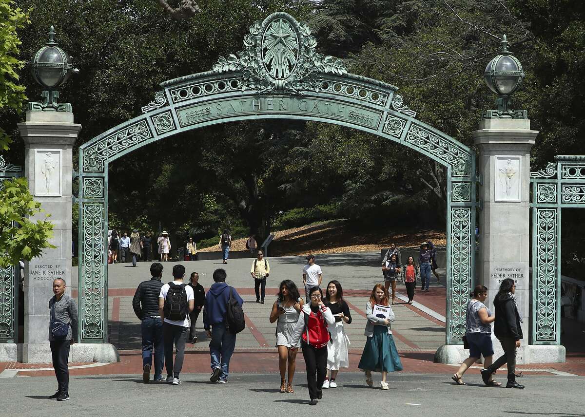 FILE - In this May 10, 2018, file photo, students walk past Sather Gate on the University of California at Berkeley campus in Berkeley, Calif. The University of California has accepted a record number of freshmen and transfer students that includes the most ever from California for the 2019-20 academic year. The university system said Monday, July 22, 2019, its nine undergraduate campuses accepted 71,655 California freshmen and 26,700 students who will transfer from California community colleges. (AP Photo/Ben Margot, File)