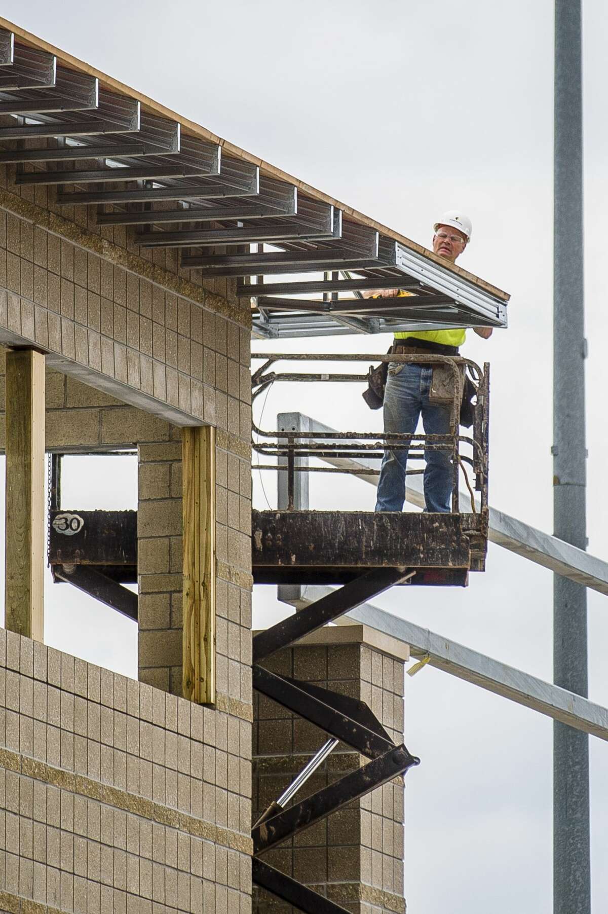 Construction workers with Three Rivers Corporation work on the new press box at Midland Community Stadium on Tuesday, July 23, 2019. (Katy Kildee/kkildee@mdn.net)