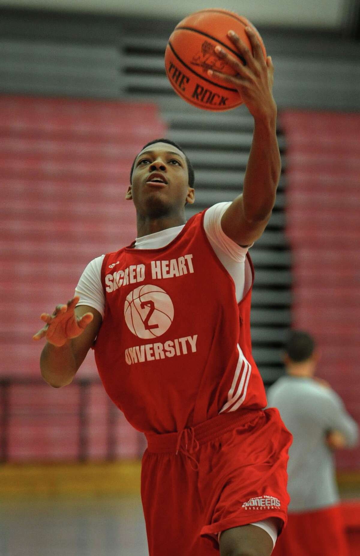 Sacred Heart University’s Evan Kelly of Norwalk drives in for a lay-up during basketball practice at the Pitt Center.