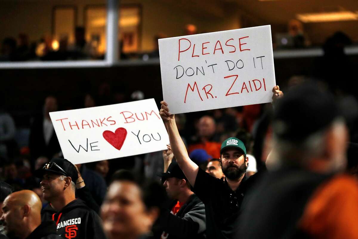 Wearing a Madison Bumgarner jersey, Adam Serrano and his son Christian, 5  1/2, settle into their seats for the Giants game against the Chicago Cubs  at Oracle Park in San Francisco, Calif.