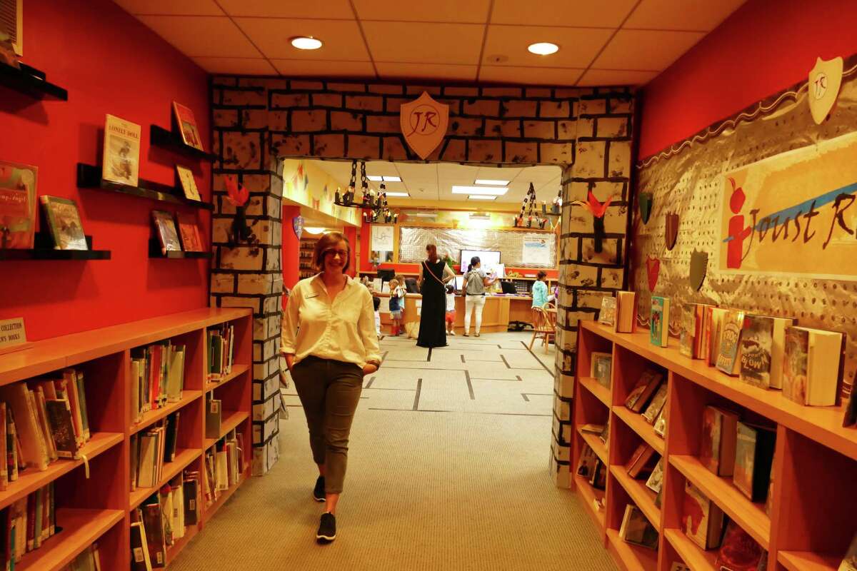 Marie Aspinwall walks out the entrance of the children's room at the New Canaan Library that has been decorated for the very popular Joust Read program. She told the Advertiser on July 18. 2019 about the unprecedented attendance for summer reading.