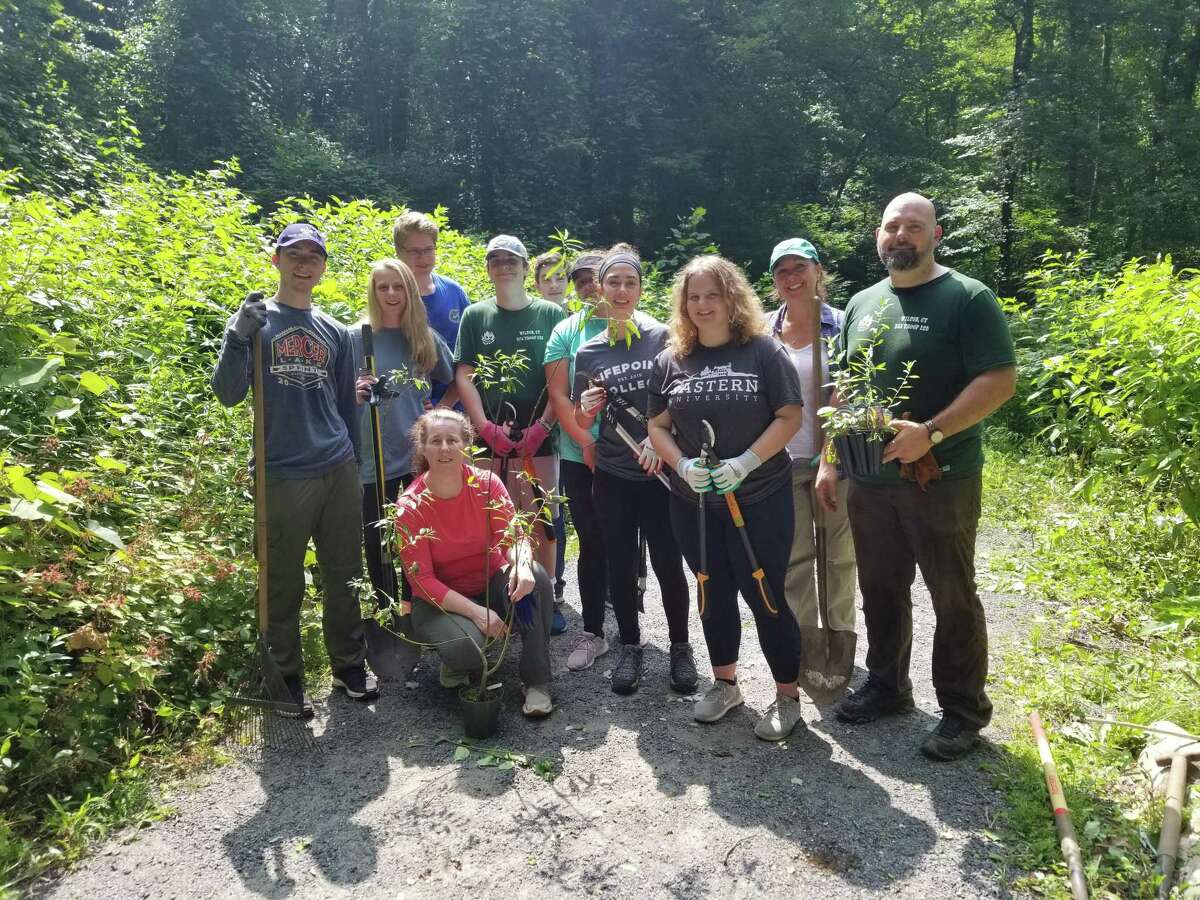 Seamus Masone, far left, with Scoutmaster Sean Heiligenthaler, far right and Assistant Scoutmaster Masone, in front. They are joined by Seamus’ family, friends and fellow Scouts.
