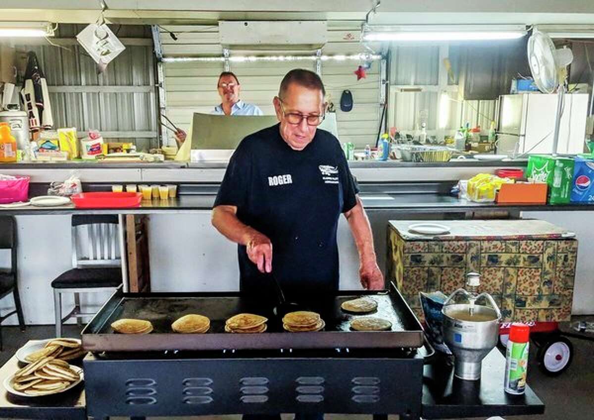 Gladwin City Councilman Roger Gardner flips pancakes Saturday morning during the fly-in at the Gladwin Zettel Memorial Airport, which was sponsored by the Gladwin Pilots Association. (Tereasa Nims/for the Daily News)
