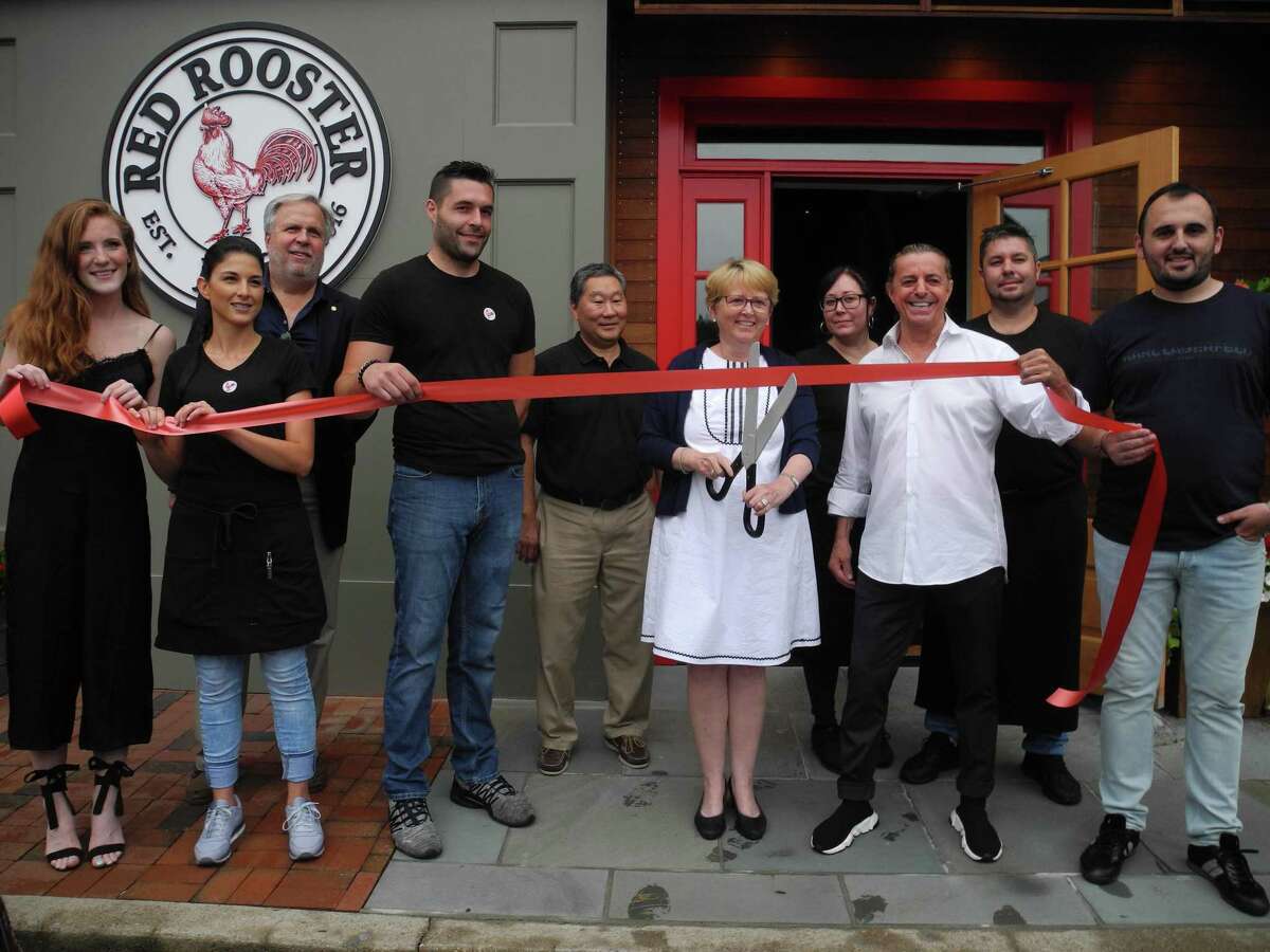 At the ribbon-cutting for Red Rooster on July 23 were, from left, Shannon Quinlan, Alejandra Perez, Chamber board member Patrick Russo, Sal Trichilo, Chamber board member Tom Sato, First Selectwoman Lynne Vanderslice, Fabiana DeOliveira, owner Tony Ramadini, Louis Rezende and Damir Bislimi.