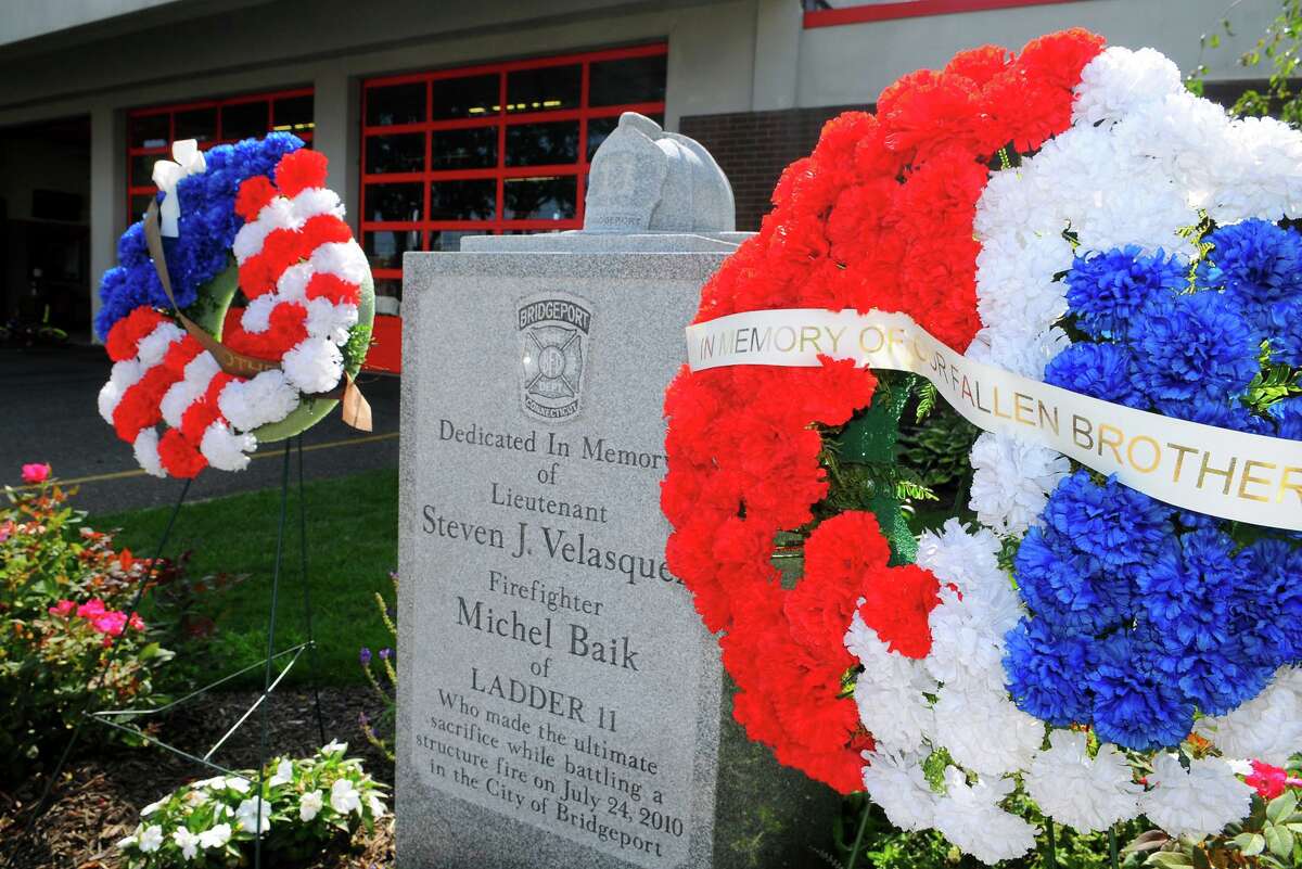 A memorial to firefighters Michel Baik and Lt. Steven Velasquez, at the fire station on Ocean Terrace in Bridgeport, Conn., on Wednesday July 24, 2019. The firefighters died while fighting a fire on Elmwood Ave, in Bridgeport, on July 24, 2010.