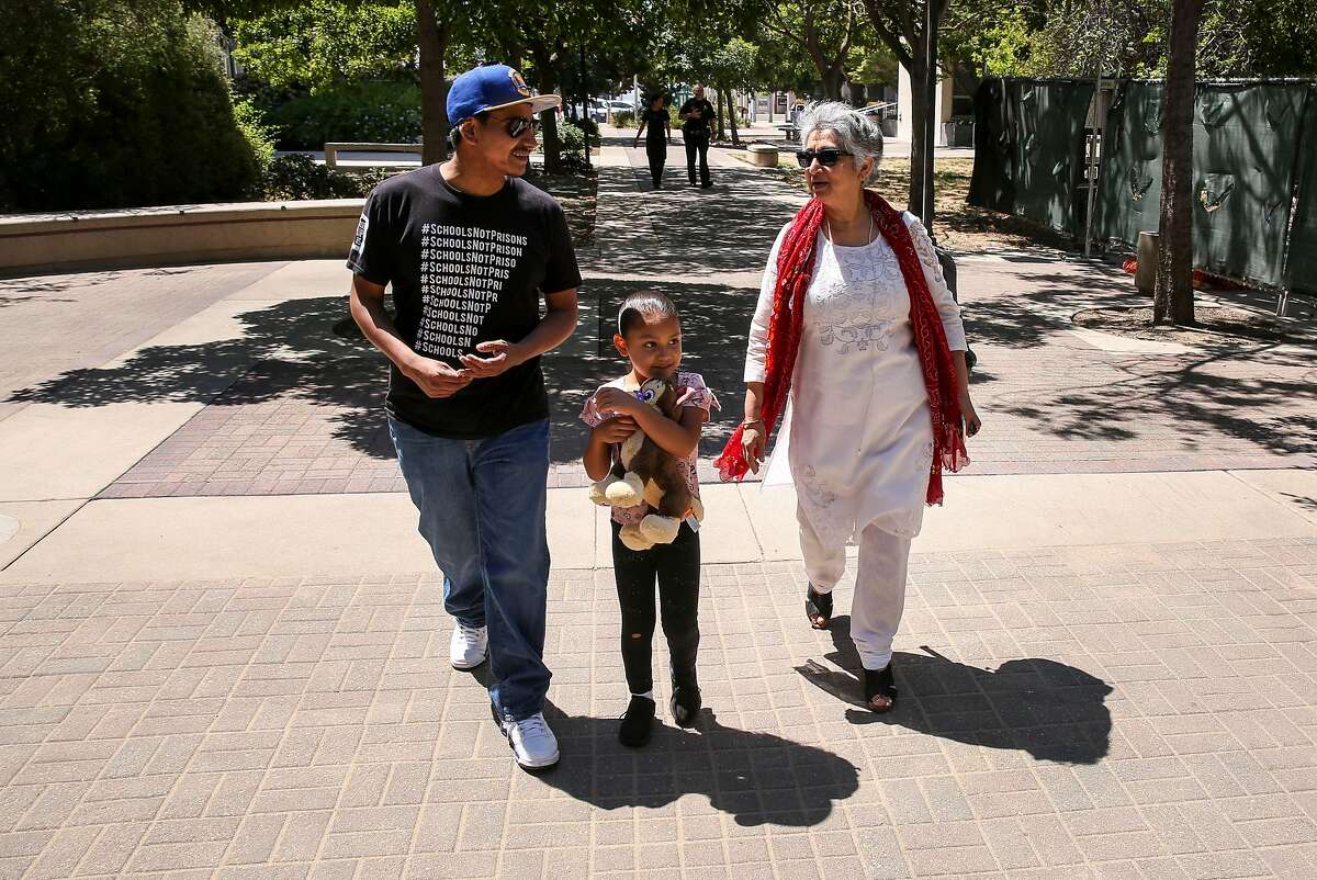 San Mateo County Juvenile Justice and Delinquency Prevention Commissioners Daniel Casillas (left) and Sonoo Thadaney Israni walk with Casillas’ niece, Isabella Narravette, outside the Redwood City Hall of Justice.