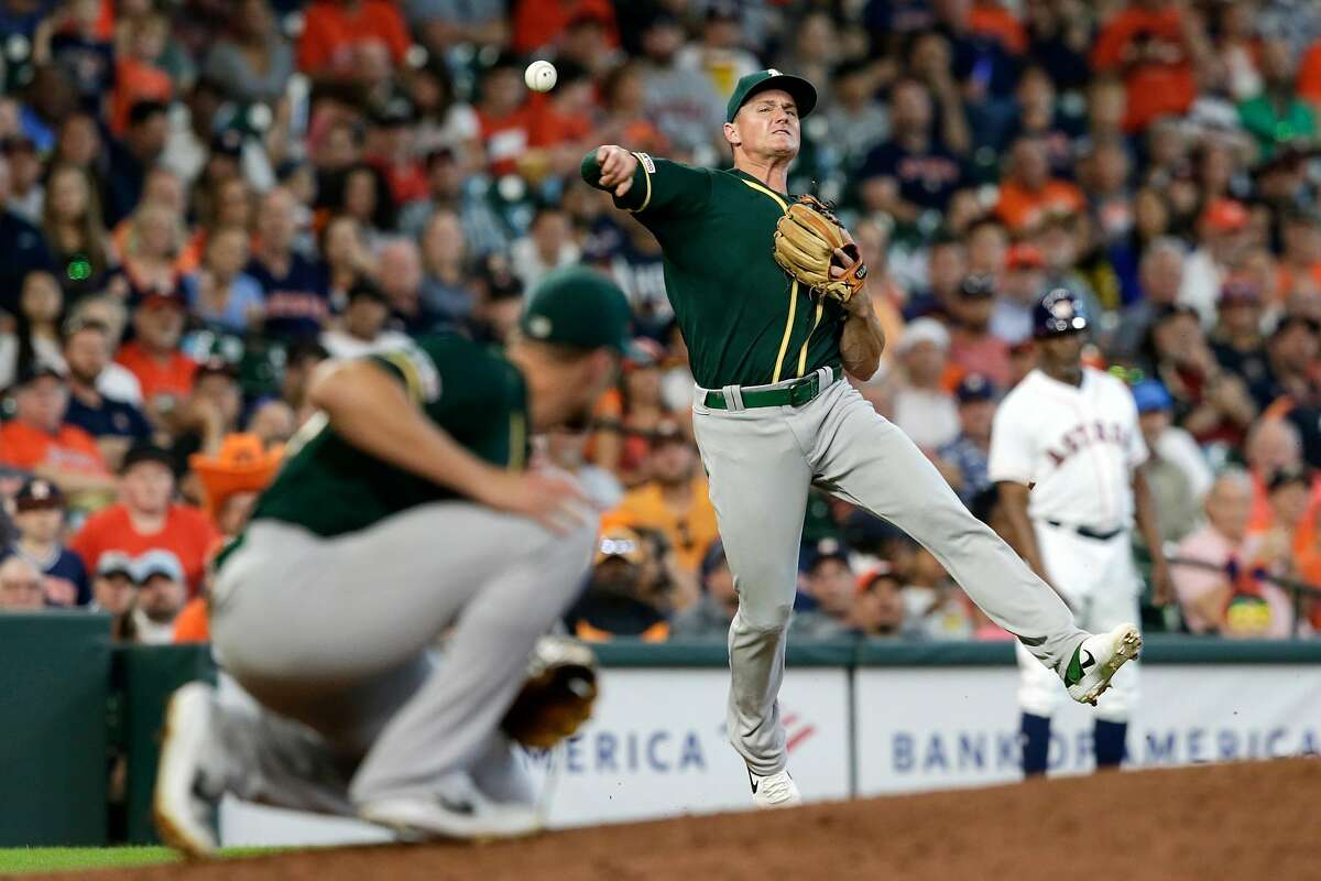 HOUSTON, TX - JULY 24: Matt Chapman #26 of the Oakland Athletics throws out George Springer #4 of the Houston Astros in the eighth inning at Minute Maid Park on July 24, 2019 in Houston, Texas. (Photo by Tim Warner/Getty Images)