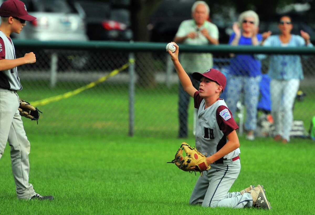North Haven's Brandon Stevens (2) shows he caught a Darien pop fly during the Section 1 championship game on Wednesday in Trumbull.