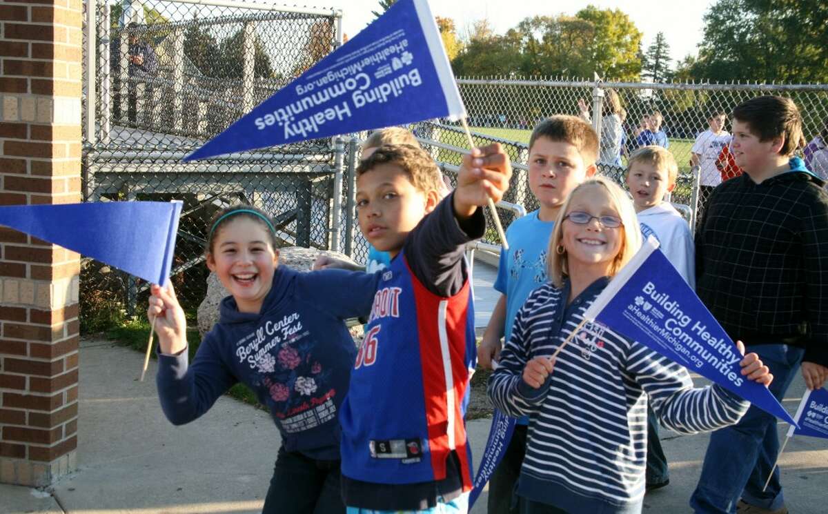 STAYING ACTIVE: G.T. Norman Elementary School students show off their flags and blue attire in support of a healthy community campaign funded by a $32,000 grant from Blue Cross Blue Shield. (Pioneer photos/Lauren Fitch)