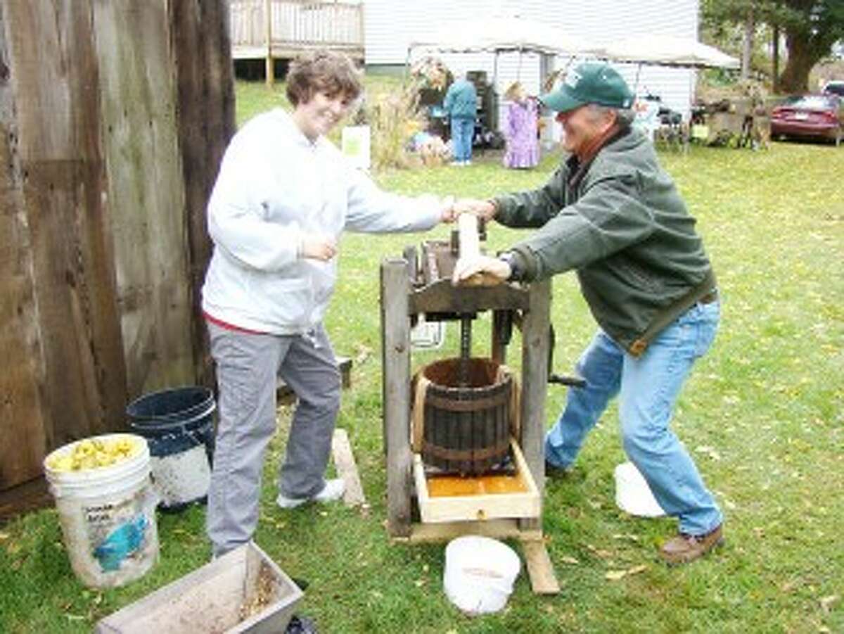 CELEBRATING AUTUMN: Participants pressed and sold fresh cider at last year’s Remus Fall Festival. Apple cider making, rail splitting and a farmers market are among the activities scheduled at the historical society again this year. (Pioneer file photo)