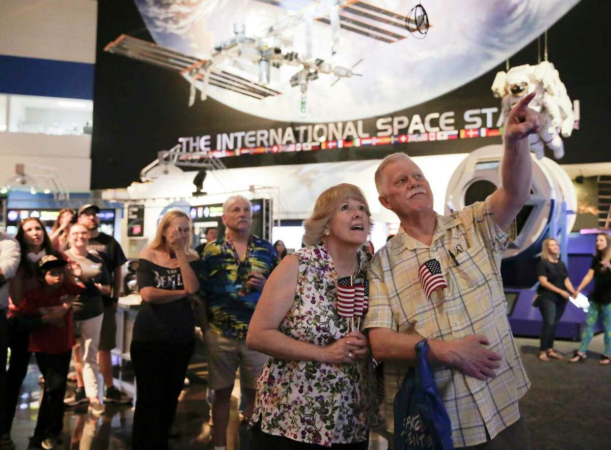 John and Wendy Largen of Seabrook, Texas, watch as footage of the Apollo splash down is shown at Space Center Houston on Wednesday, July 24, 2019.