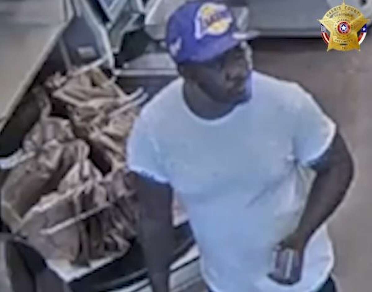 A second suspect is described as a medium-sized black male with a thin goatee also between 30-40 years of age seen on camera wearing a white t-shirt, black athletic pants, a purple LA Lakers ball cap and red Nike slides.