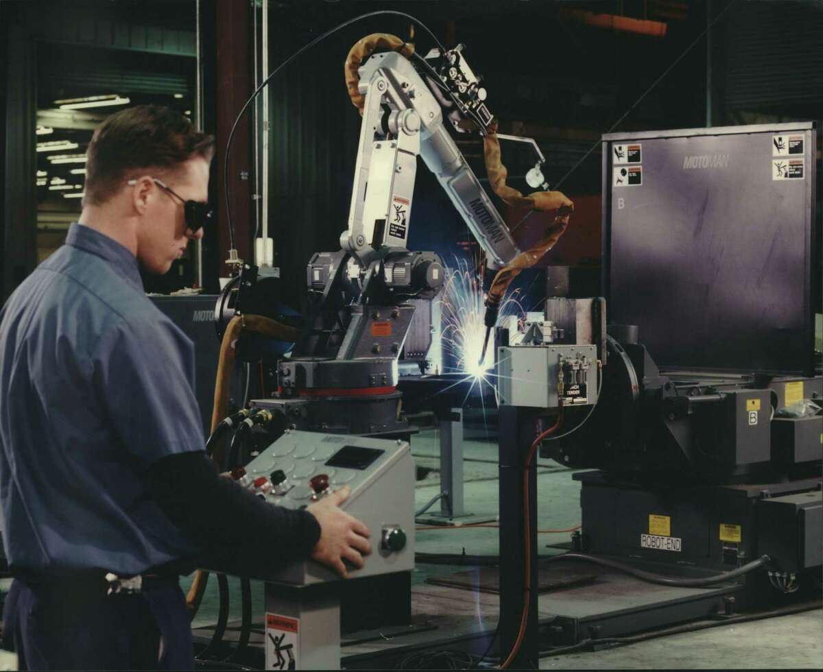 A new automated welding robot at work in the expanded Houston, Texas plant of Mitsubishi Caterpillar Forklift America Inc. Robots