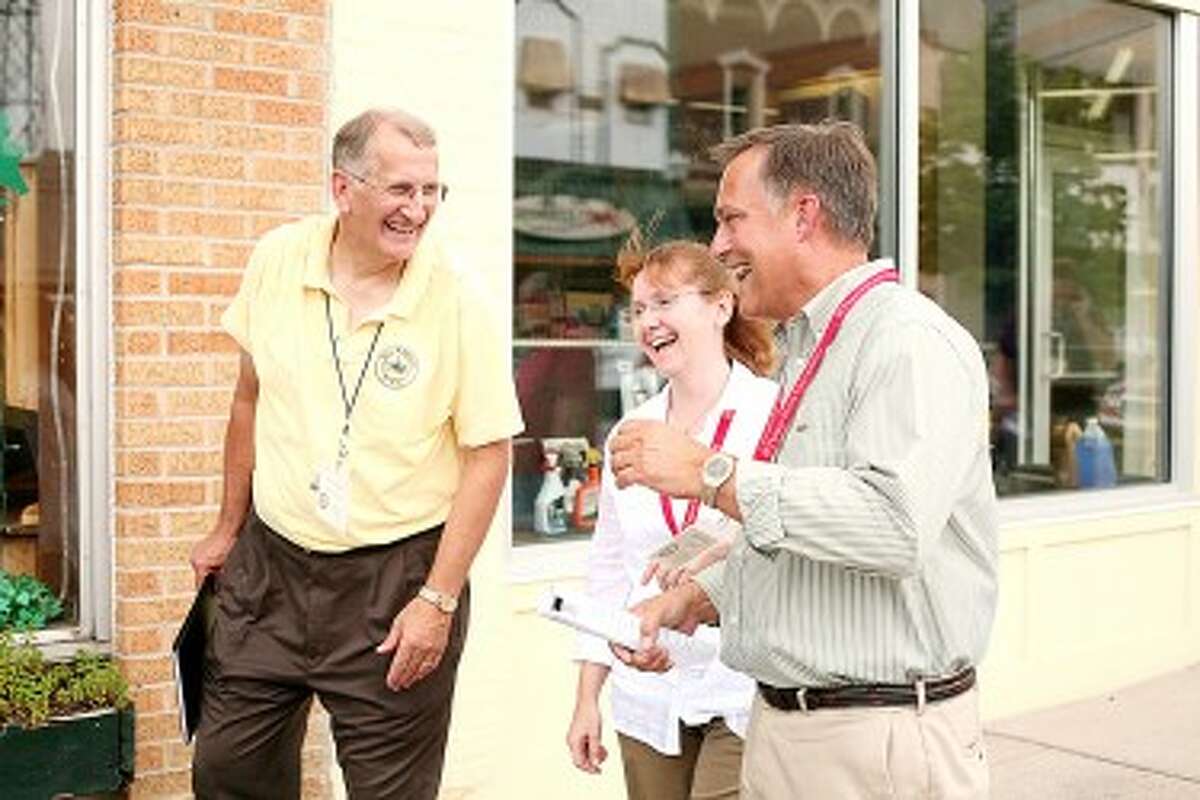 MAYOR EXCHANGE: Big Rapids Mayor Mark Warba (right), Manistee Mayor Colleen Kenny (center) and Big Rapids City Manager Steve Sobers share a laugh while walking along N. Michigan Ave. in July during a mayor exchange initiative. Big Rapids officials traveled to Manistee in June.