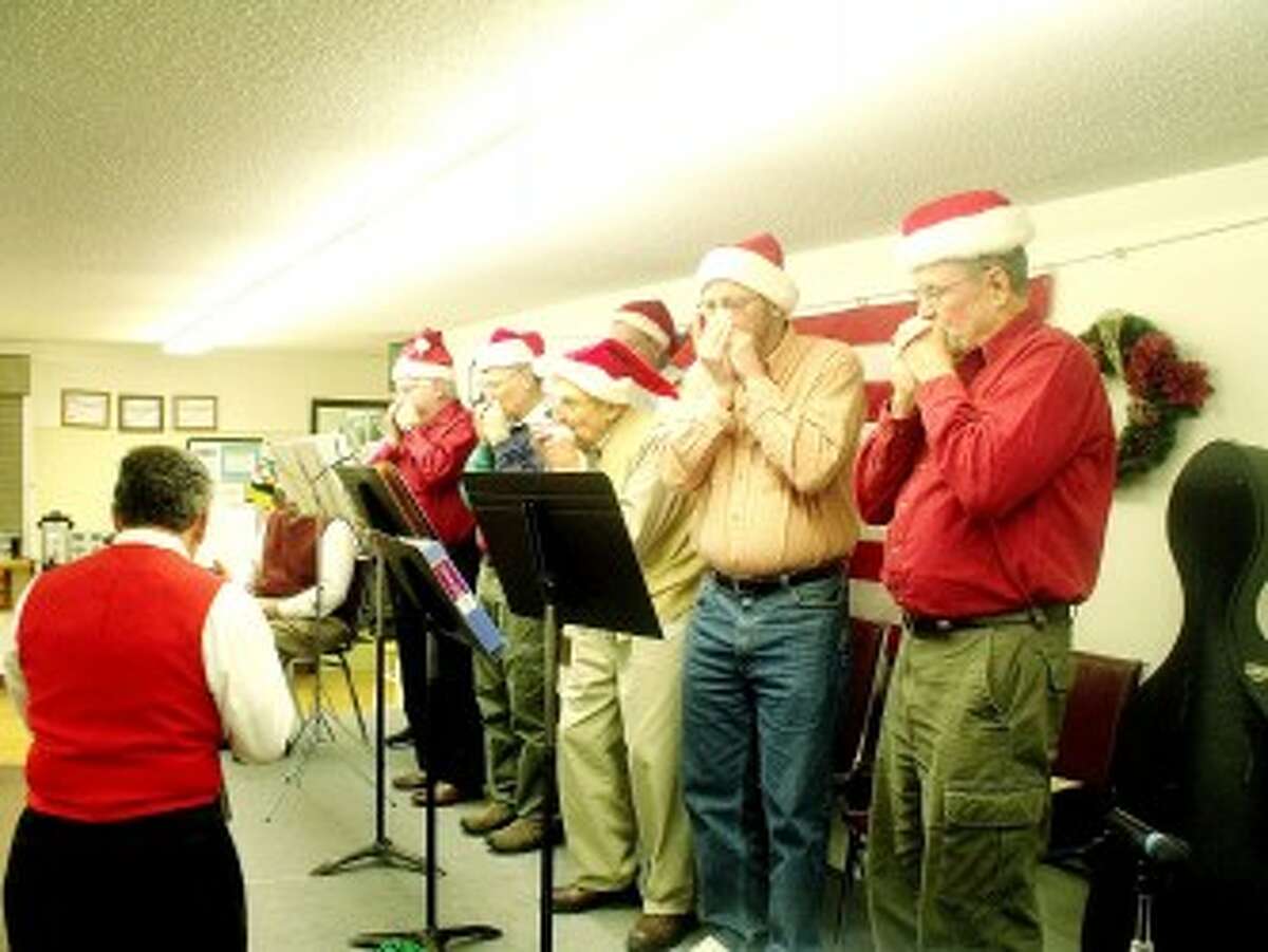 HOLIDAY PERFORMANCE: The harmonica group was highlighted at the Mecosta County Senior Center Christmas Party in December and also joined in during Tuba Bach presentations last fall in Big Rapids. (Pioneer file photo)