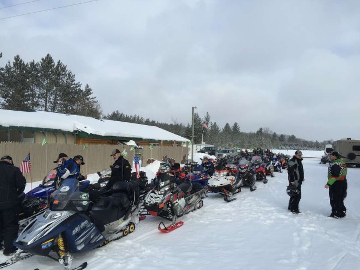 ROW OF SLEDS: Dozens of snowmobiles are lined up outside a stop during the Wertz Warriors Annual Snowmobile Endurance Ride. The ride raises money for the Special Olympics Michigan winter games.