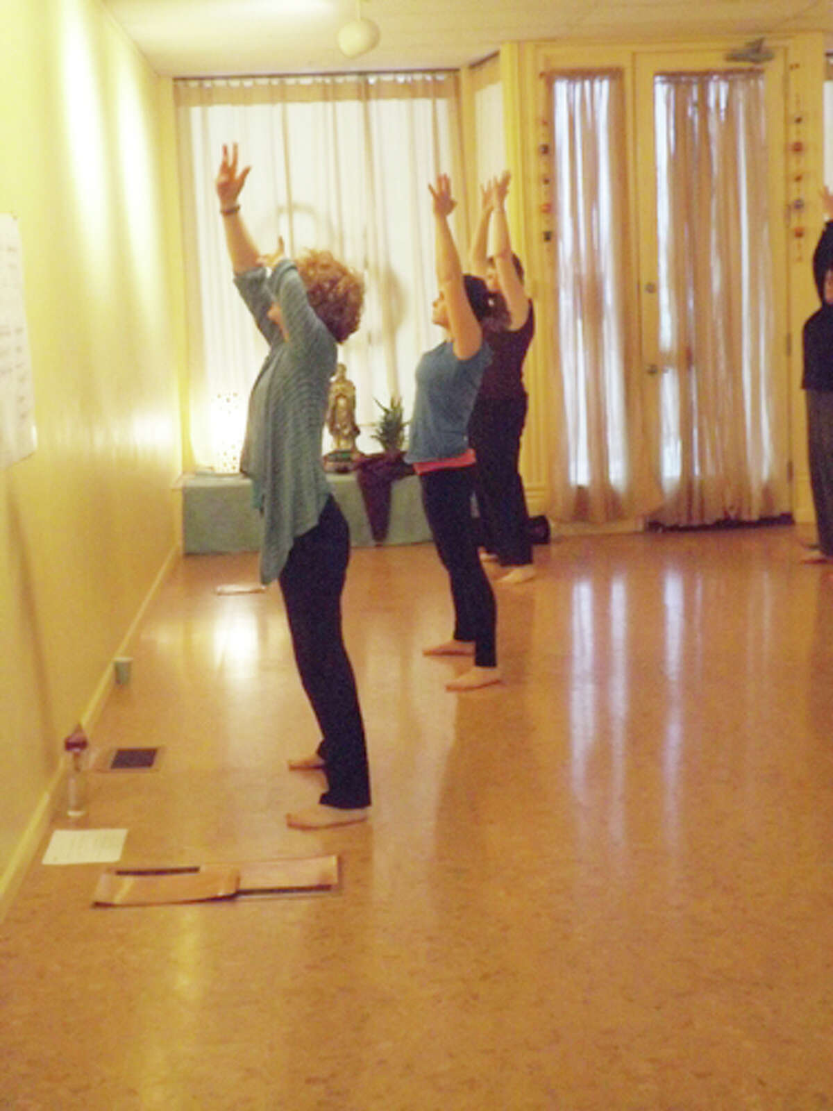 FESTIVAL YOGA: Lisa Sandin, Shelby Austin and Pat Barrett begin a session of Nia movement.The Nia class reach and stretch at the start of a movement session. The yoga event Monday was part of the 2014 Festival of the Arts.