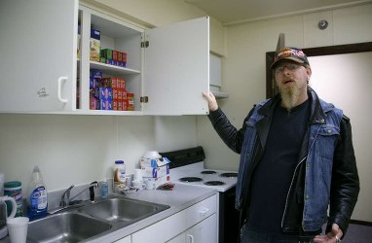 GIVING BACK: “Rev” Young gives a tour of the kitchen and dining area at Our Brother’s Keeper homeless shelter in Big Rapids. After spending 18 months homeless years ago, Young wanted give back by volunteering at the local shelter. (Pioneer photos/Lauren Fitch)
