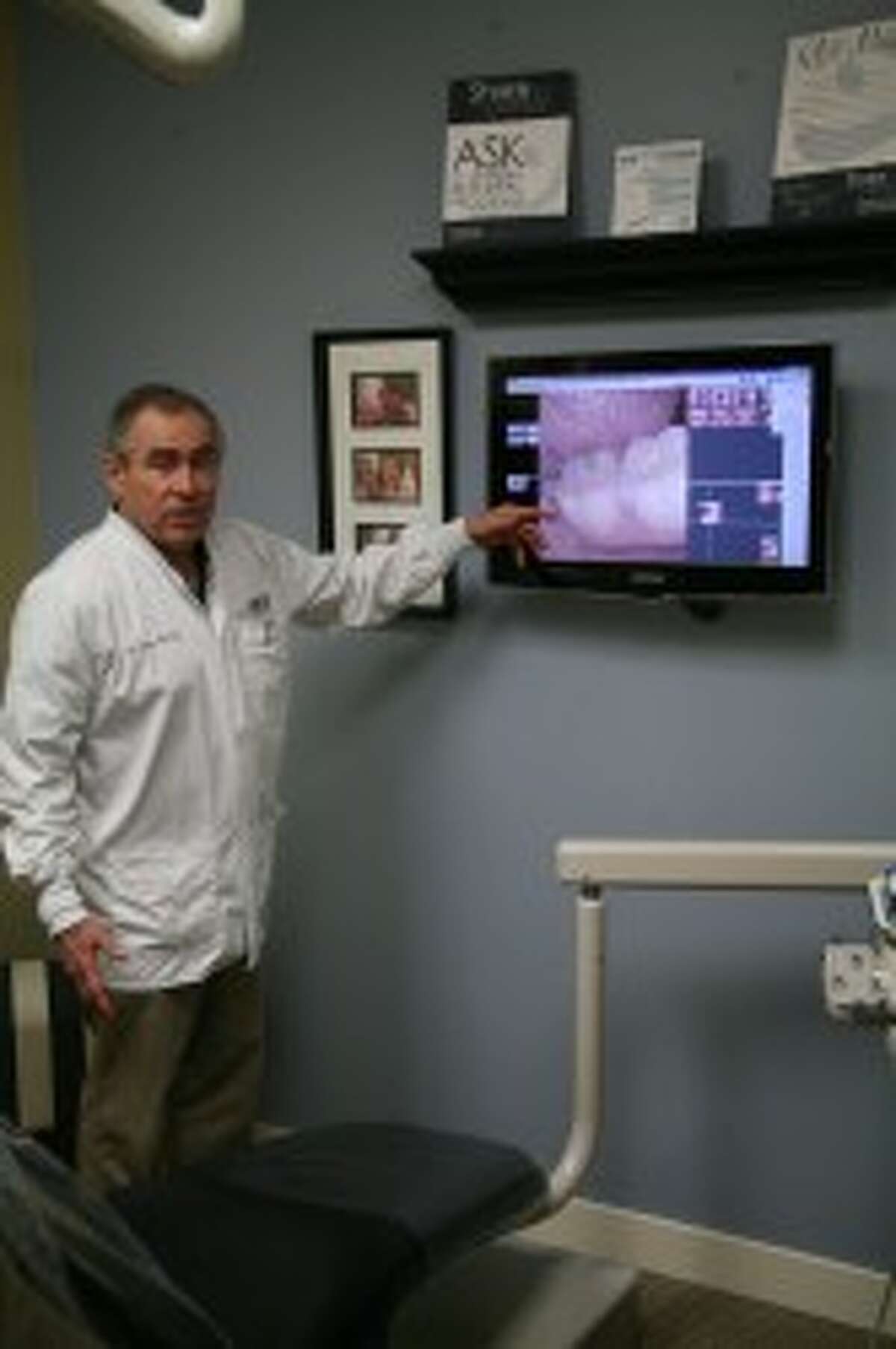 NEW LOCATION: Dr. Bob Scharp talks about the equipment at Big Rapids Dental Health Care’s new downtown location. The dental office reopened at its new location on Jan. 7.