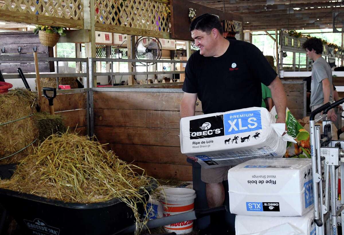 Jeff King of Kings Brothers Dairy unloads hay for his dairy cows in the dairy barn at the Saratoga County Fair on July 25, 2019, in Ballston Spa, N.Y. (Catherine Rafferty/Times Union)