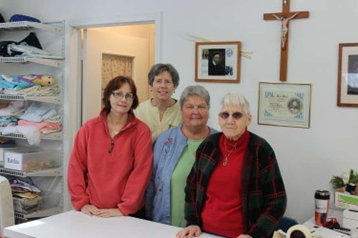 Without volunteers St. Vincent de Paul would be unable to keep doors open. From left to right, Carol Miller, Mary Greene and Nancy Mitchell work with store manager Thrasilla Renee. (Pioneer photos/ Lauren Gentile)