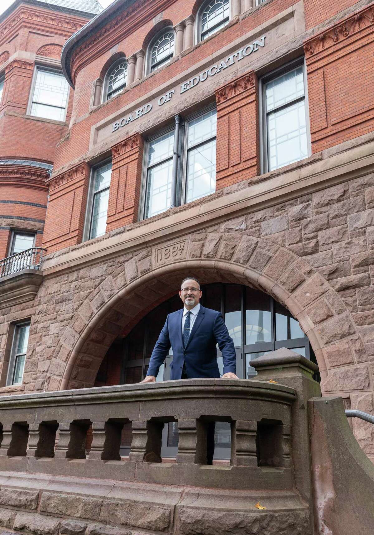 Dr. Miguel Cardona in front of the building in Meriden where for the past four years he has been the assistant superintendent of schools for teaching and learning.
