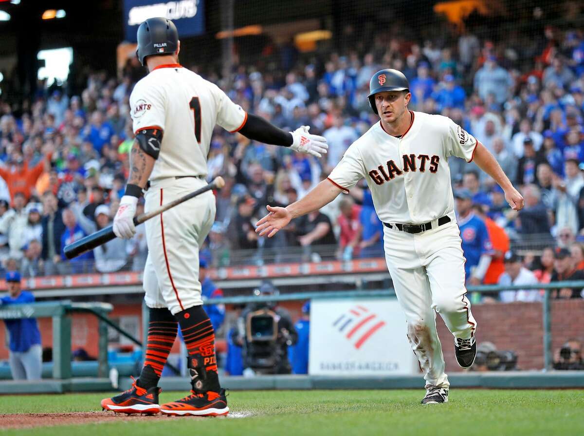 San Francisco Giants' Alex Dickerson scores on a Mike Yastrzemski sacrifice fly in 2nd inning against Chicago Cubs during MLB game at Oracle Park in San Francisco, Calif., on Tuesday, July 23, 2019.