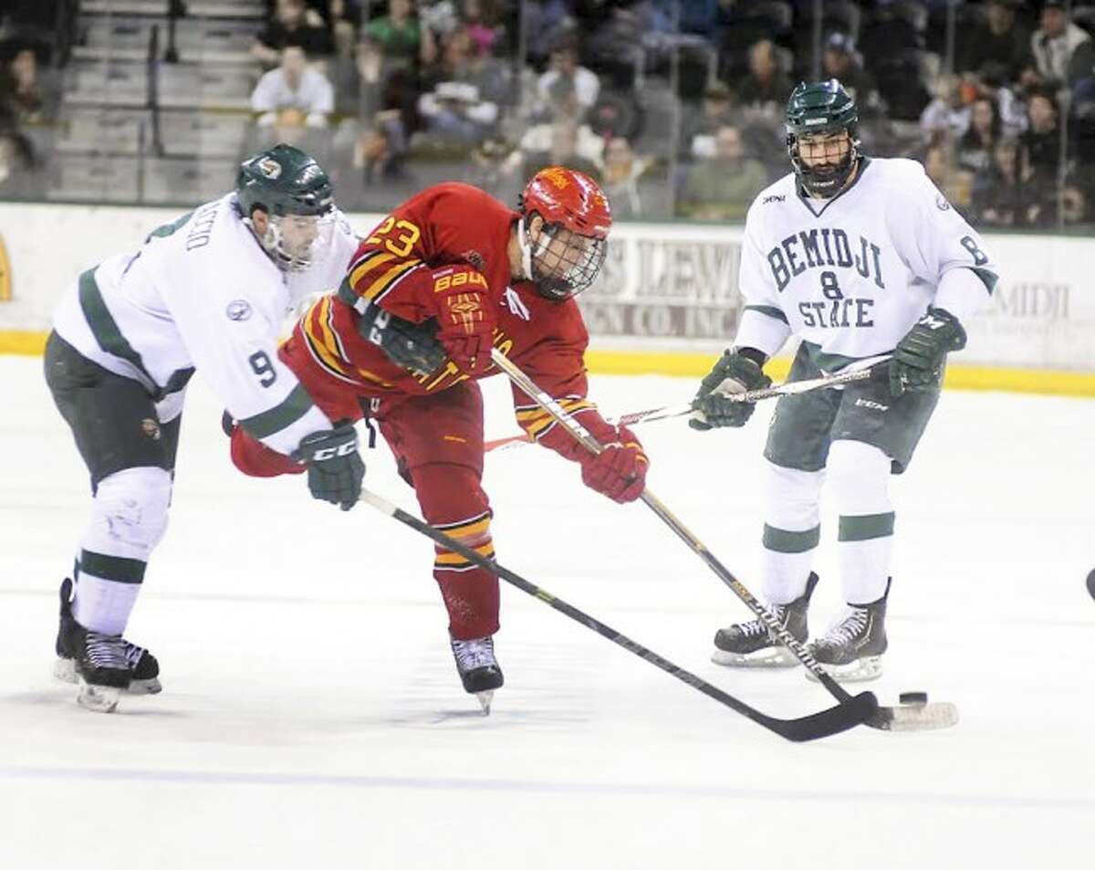 Ferris State defenseman Brandon Anselmini (middle) attempts to dump the puck in during the 2015 season. (Pioneer file photo)