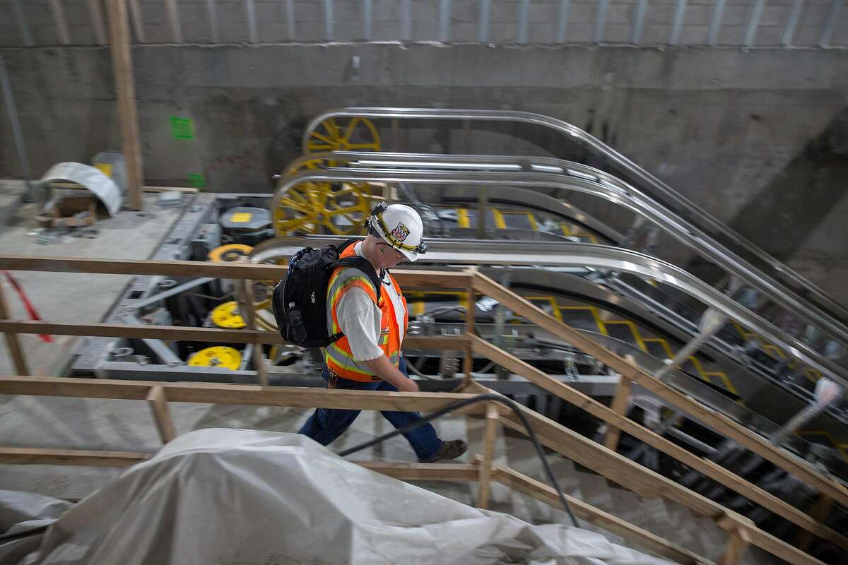 Laborers at work at the construction site of the Union Square/Market St. Central Subway Station. According to officials it will still take months of contraction work before the station officially opens. Thursday, July 25, 2019. San Francisco, Calif.