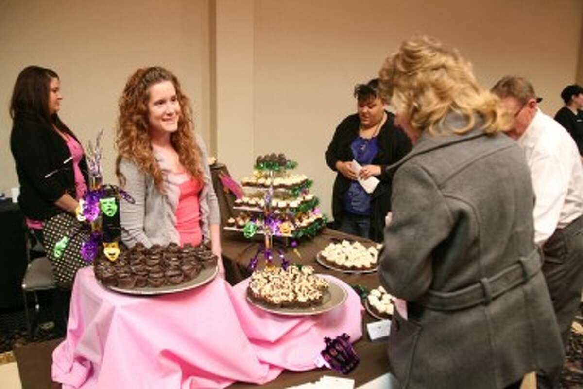 HELLO CUPCAKE: Nyssa Meyer (left), of Hello Cupcake, helps Connie Koepke, director of the Mecosta County Area Convention and Visitors Bureau decide which dessert to eat. (Pioneer photos/Jonathan Eppley)