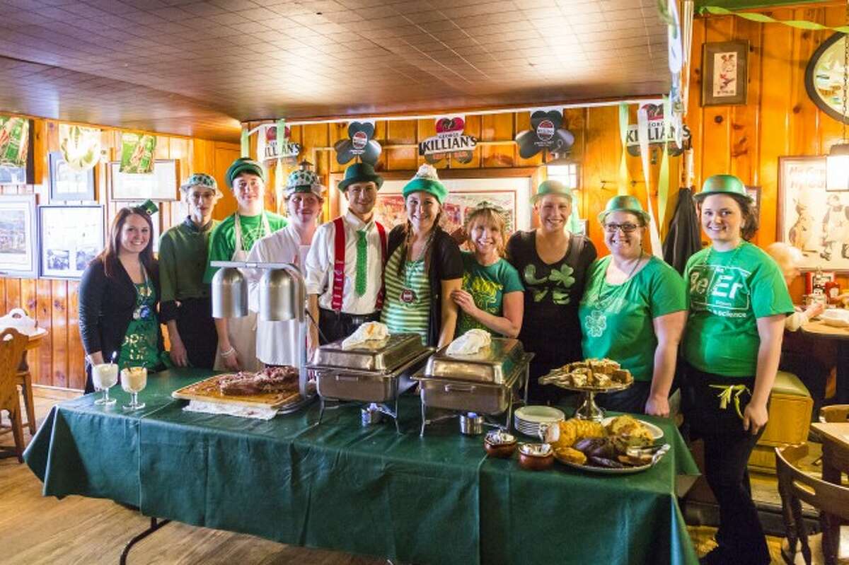 WORKING THE HOLIDAY: The staff at Schuberg’s Bar and Grille take a break from working on St. Patrick’s Day. The bar’s annual corned beef buffet is a popular favorite among area residents.