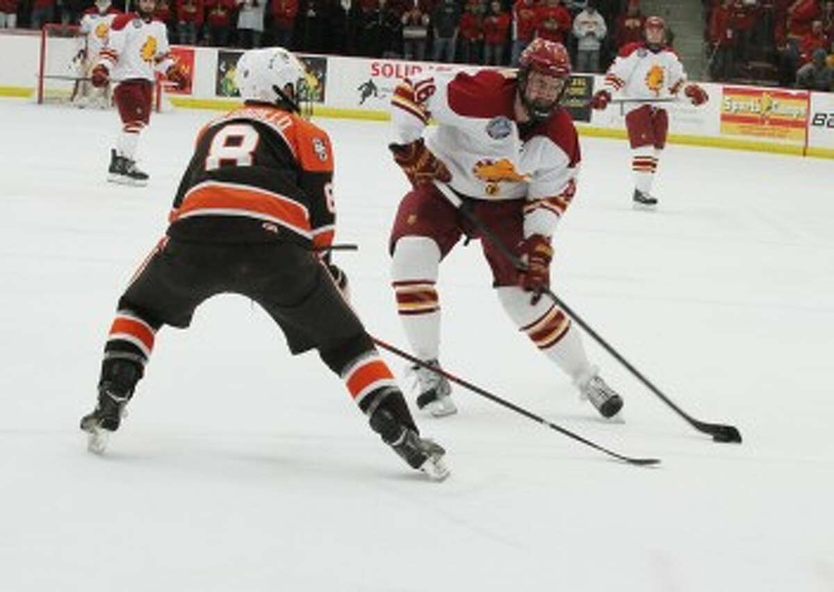 ONE ON ONE: Ferris State's Garrett Thompson (right) looks to put a shot on net against Bowling Green on Friday. FSU dropped the game 2-1. (Pioneer photo/Martin Slagter)