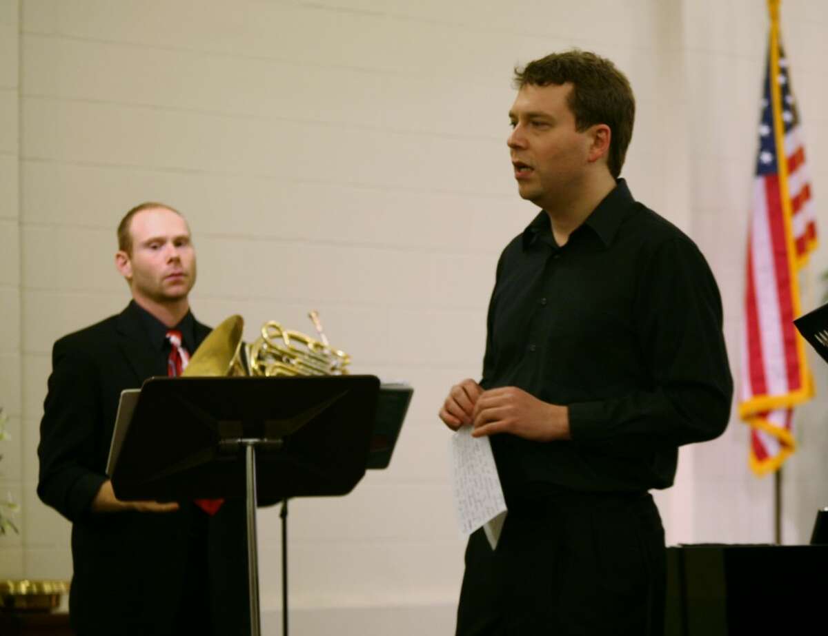 BRASS ROOTS: Pianist Yevgeny Morozov (right) introduces the next piece in Friday’s Brass Roots Trio concert. Dan Wions (left) plays horn.