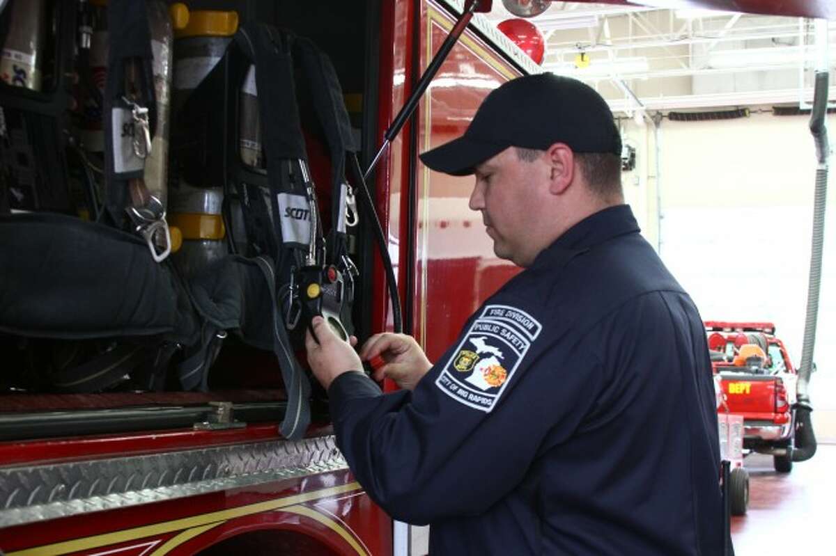 MAINTENANCE: Matthew Kidd checks an airpack on one of the department’s fire trucks.