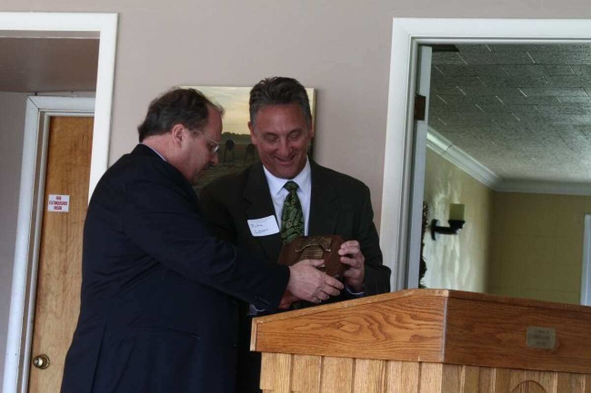 RECOGNITION: Tom Lyons accepts the Mecosta County Liberty Bell Award from John Lewis during Friday's Mecosta-Osceola Bar Association’s Law Day luncheon.