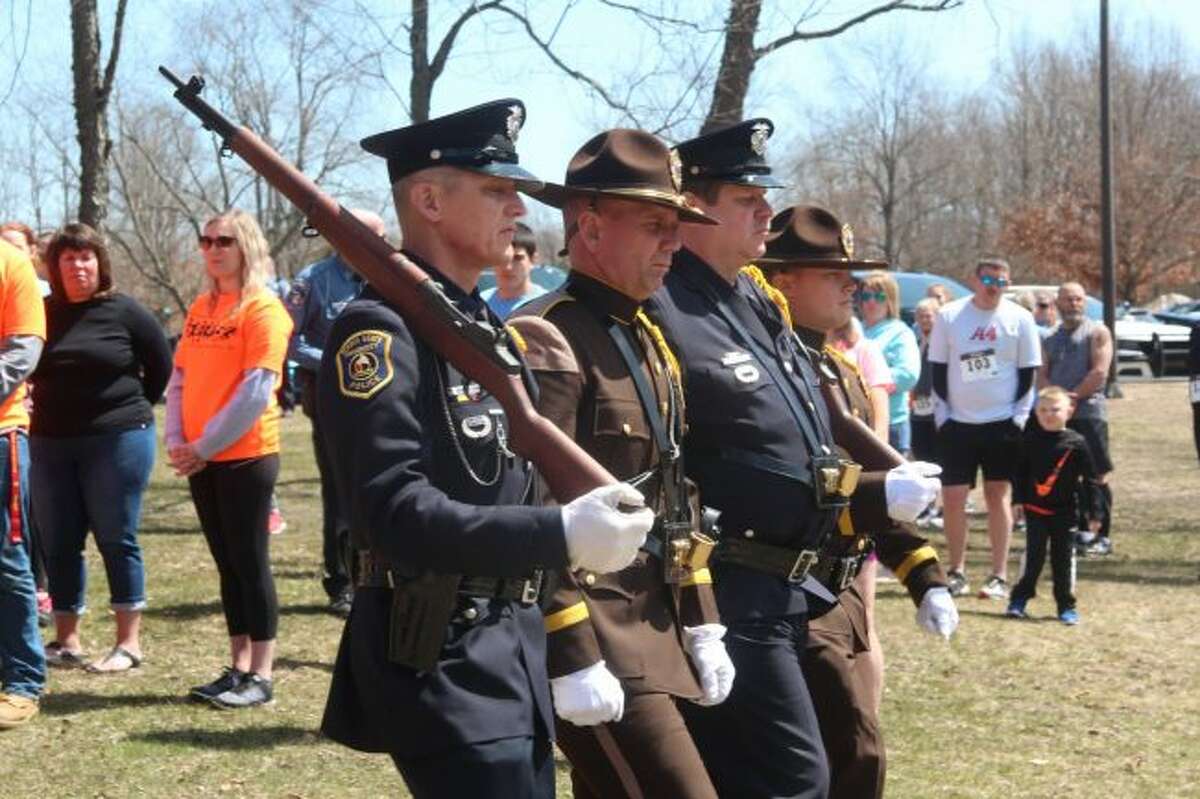An honor guard is dismissed following the Pledge of Allegiance during Sunday's memorial service at the Fallen Officer's 5K Run/Walk Sunday afternoon at Northend Riverside Park in Big Rapids. (Pioneer photo/Brandon Fountain)