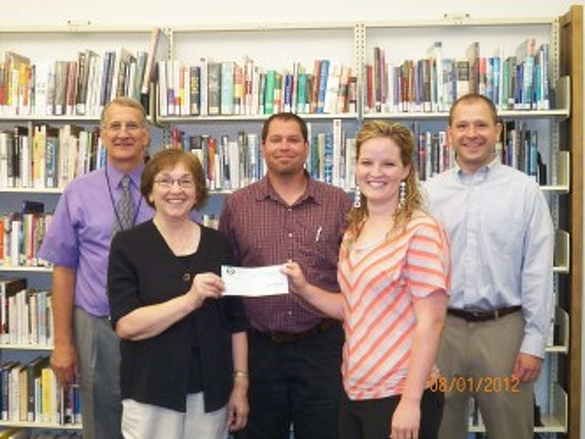 ANONYMOUS DONATION: Mary Ryan (front left), of the Big Rapids Community Library Renovation Team and president of the Friends of the Big Rapids Community Library, presents a $20,000 check from an anonymous donor to interim library Director Miriam Andrus for the $853,000 library renovation project. Also pictured (back, from left to right) are City Manager Steve Sobers, Department of Neighborhood Services Director Mark Sweppenheiser and city Treasurer Jon Locke. (Courtesy photo)